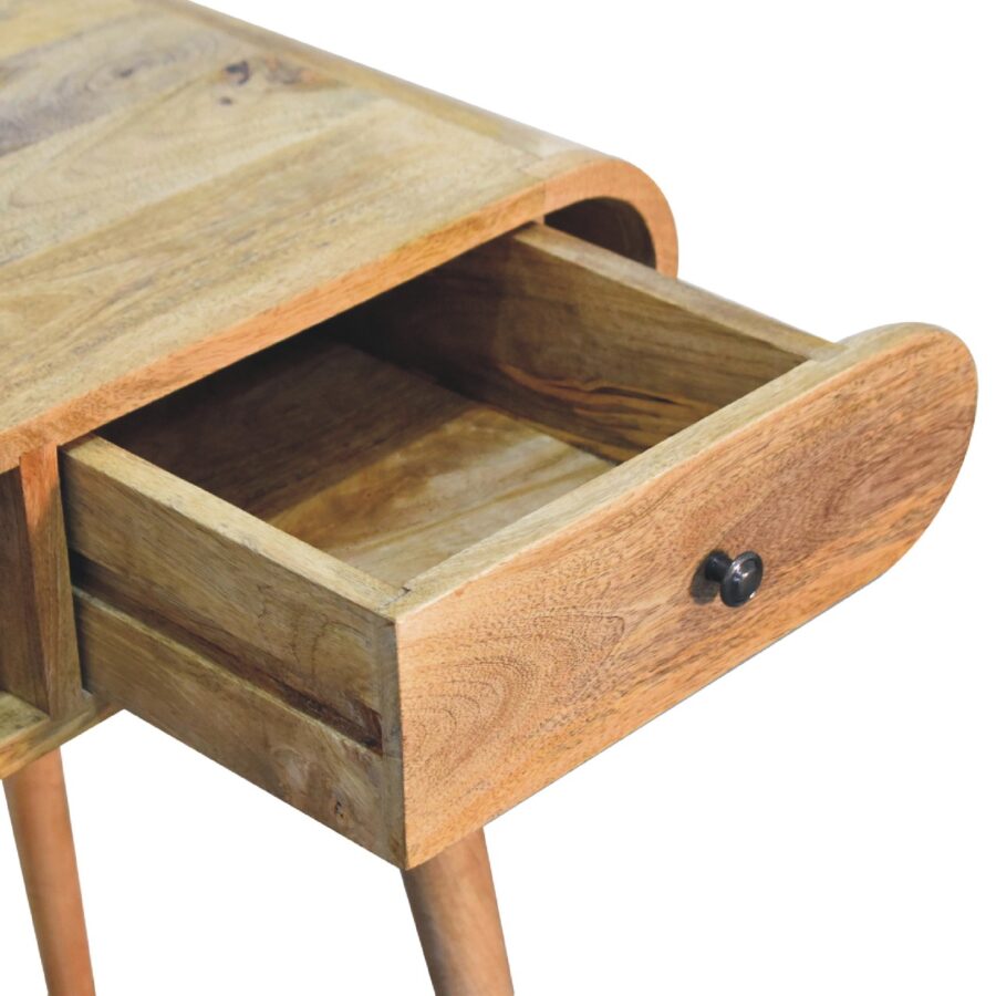 Wooden bedside table with open drawer.